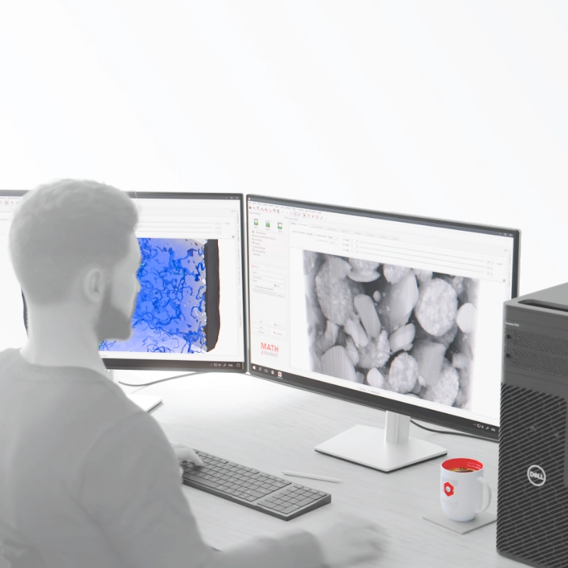 Ein Anwender bei der Materialanalyse mit GeoDict an einer Workstation mit zwei Monitoren, die eine 3D-Mikrostruktur und eine Simulationsvisualisierung zeigen