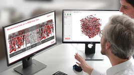 Material scientists analyzing the microstructure of a fuel cell's fiber layer on a computer using GeoDict simulation software